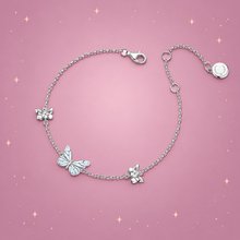 Blue Butterfly Bracelet on a dusty rose background with rose gold sparkles