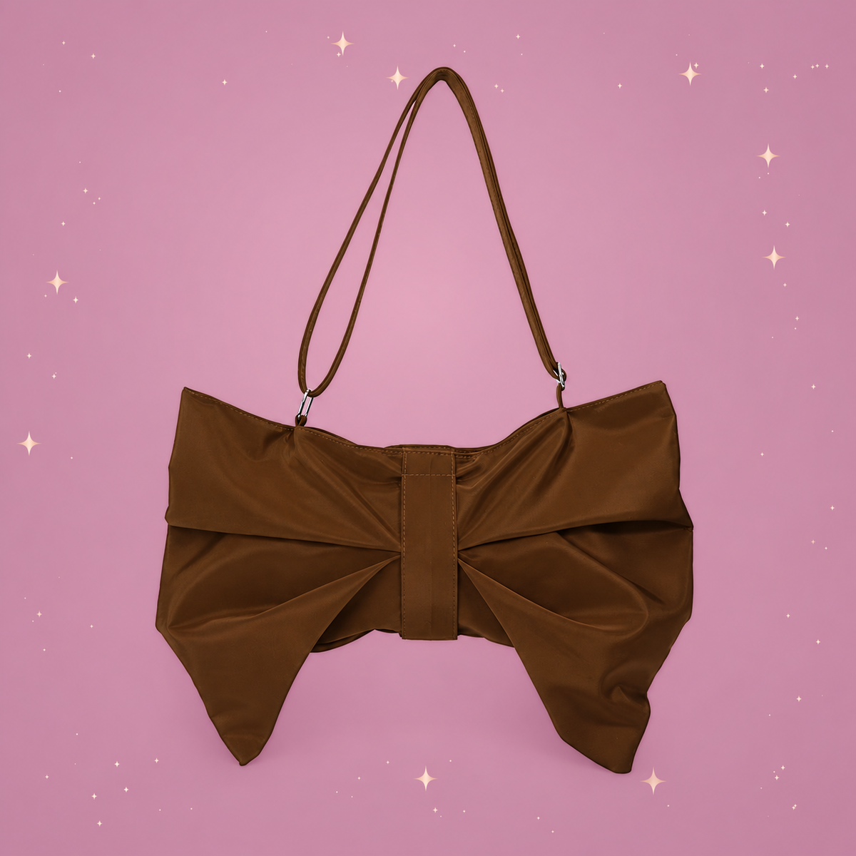 Bow Crossbody Tote on a dusty rose background with rose gold sparkles