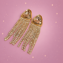 Elegant Statement Earrings on a dusty rose background with rose gold sparkles