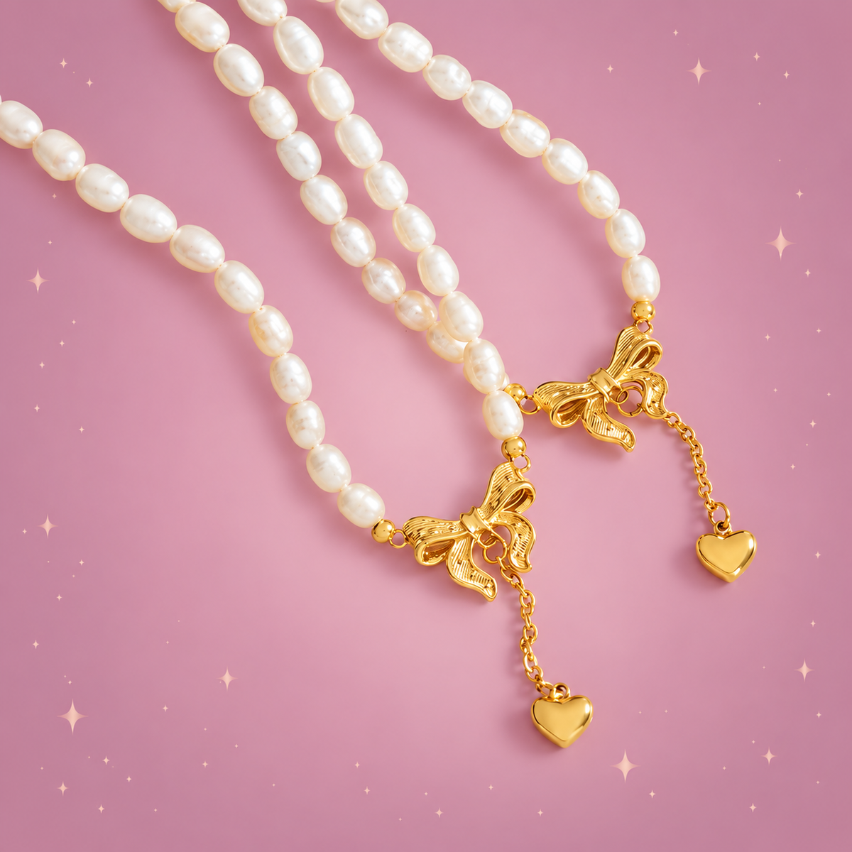 Freshwater Pearl Heart Necklace on a dusty rose background with rose gold sparkles