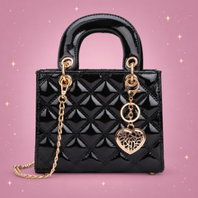 Glossy Quilted Chain Tote on a dusty rose background with rose gold sparkles