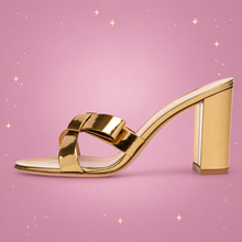 Gold Block-Heel Mules on a dusty rose background with rose gold sparkles