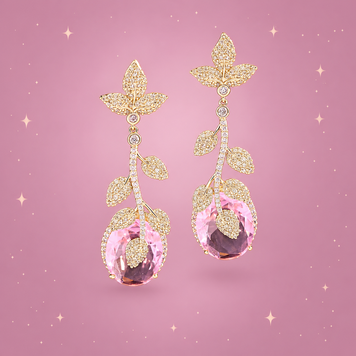 Golden Leaf Drop Earrings on a dusty rose background with rose gold sparkles