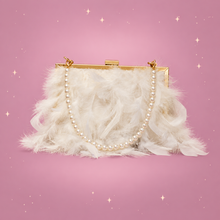 Luxy Moon Feather Clutch on a dusty rose background with rose gold sparkles