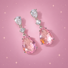 Pear Teardrop Earrings on a dusty rose background with rose gold sparkles
