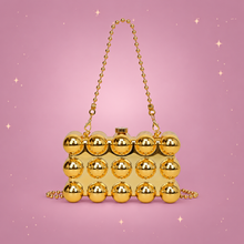 Pearl Chain Mini Lipstick Bag on a dusty rose background with rose gold sparkles