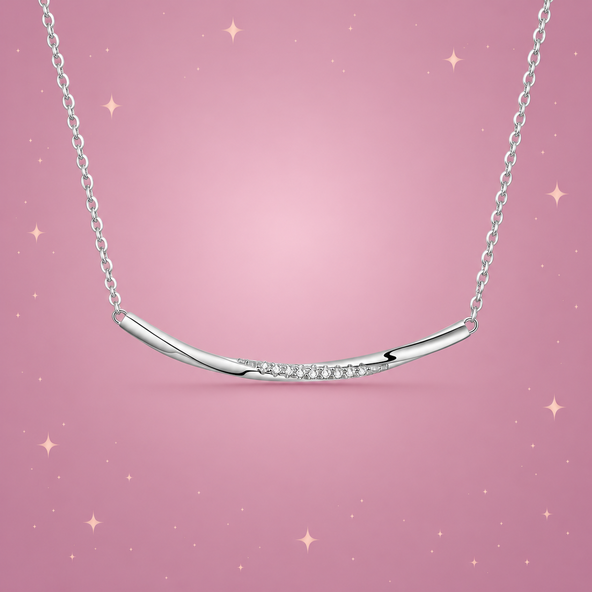 Silver Smile Necklace on a dusty rose background with rose gold sparkles