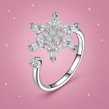 Sparkle Spinner Ring on a dusty rose background with rose gold sparkles