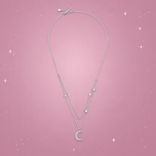 Starlight Moon Silver Necklace on a dusty rose background with rose gold sparkles