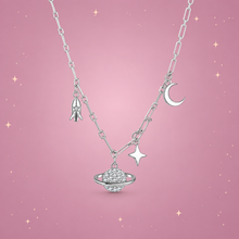 Starry Sky Silver Necklace on a dusty rose background with rose gold sparkles
