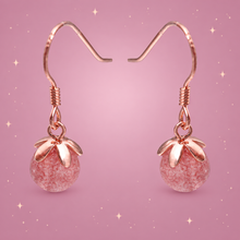 Strawberry Crystal Earrings on a dusty rose background with rose gold sparkles