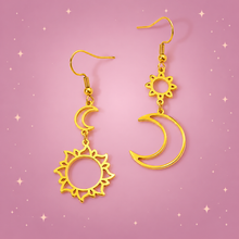Sun Moon Earrings on a dusty rose background with rose gold sparkles