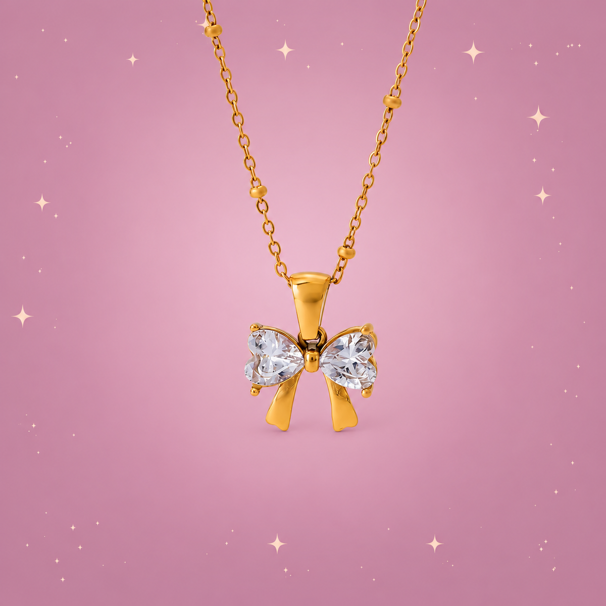 Zircon Bow Necklace on a dusty rose background with rose gold sparkles
