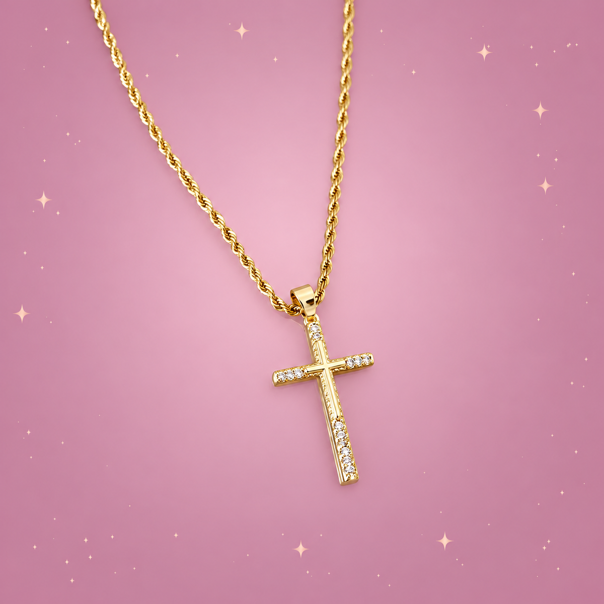 Zircon Cross Necklace on a dusty rose background with rose gold sparkles