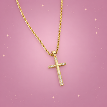 Zircon Cross Necklace on a dusty rose background with rose gold sparkles