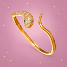 Zircon Snake Bracelet on a dusty rose background with rose gold sparkles